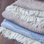 Throw From Europe 100% Cotton Gauze Waves throw beige and ocean color on wood close up