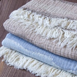 Throw From Europe 100% Cotton Gauze Waves throw beige and ocean color on wood close up