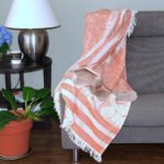 Throw From Europe 100% Cotton Reversible Jacquard Garden pattern in Rust color on sofa