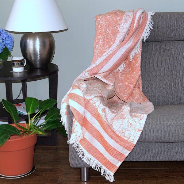 Throw From Europe 100% Cotton Reversible Jacquard Garden pattern in Rust color on sofa
