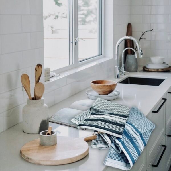 All over houndstooth pattern in flat Terry material. Tea towels in black and blue on counter