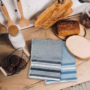 All over houndstooth pattern in flat Terry material. Tea towels in black and blue on counter