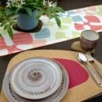 Flock and flutter design shine Runner LS looking down with pink kidney bean cork placemat from hem and tassel