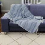 Pure cotton, Gauze throw in ocean waves pattern on dark colored sofa