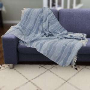 Pure cotton, Gauze throw in ocean waves pattern on dark colored sofa