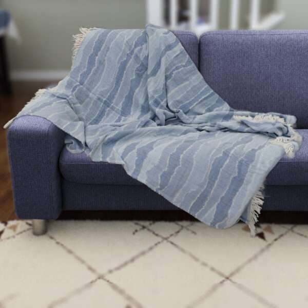 Pure cotton, Gauze throw in ocean waves pattern on dark colored sofa