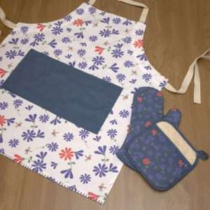 Shy dragonfly design apron with purple flowers flat from hem and tassel