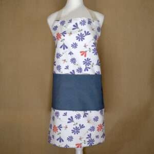 Shy dragonfly design apron with purple flowers on mannequin from hem and tassel