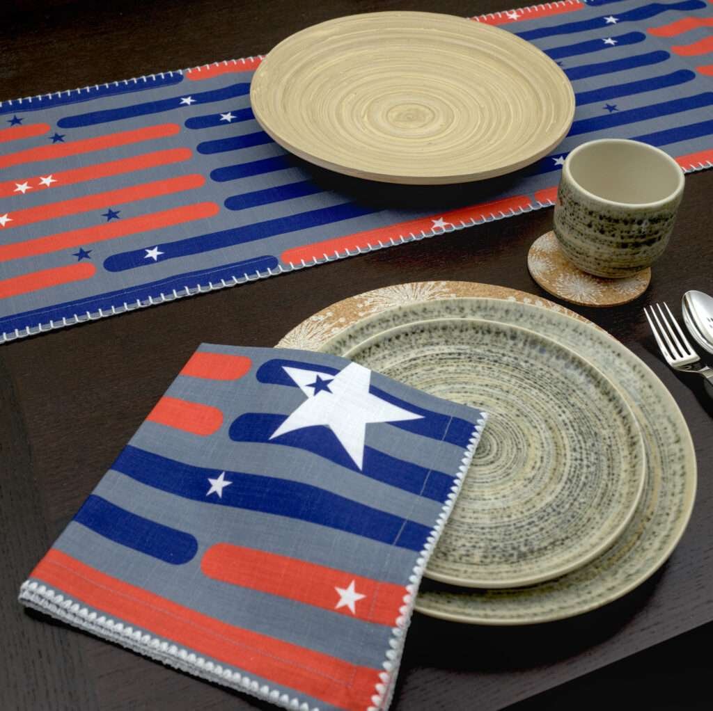 Stars and stripes design dinner napkins looking down with table runner LS from hem and tassel