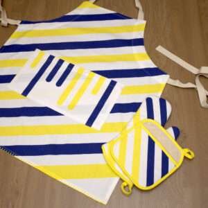 Yellow piano apron flat from hem and tassel