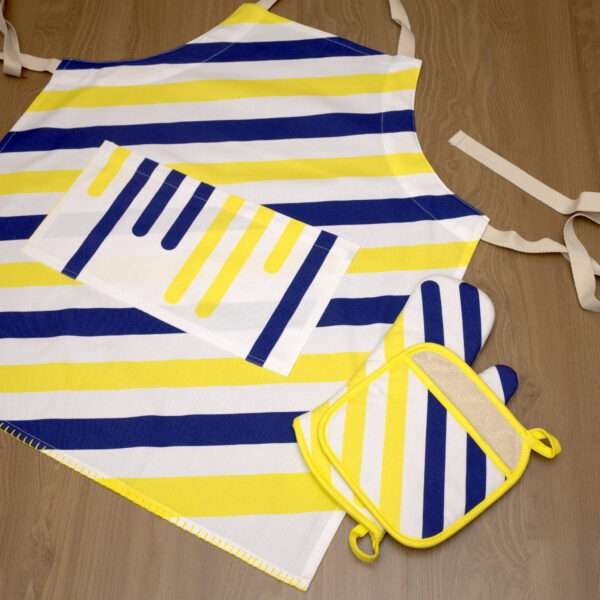 Yellow piano apron flat from hem and tassel