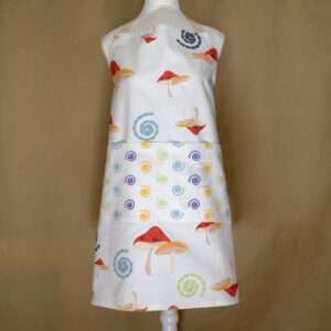 magic mushroom design apron on mannequin from hem and tassel