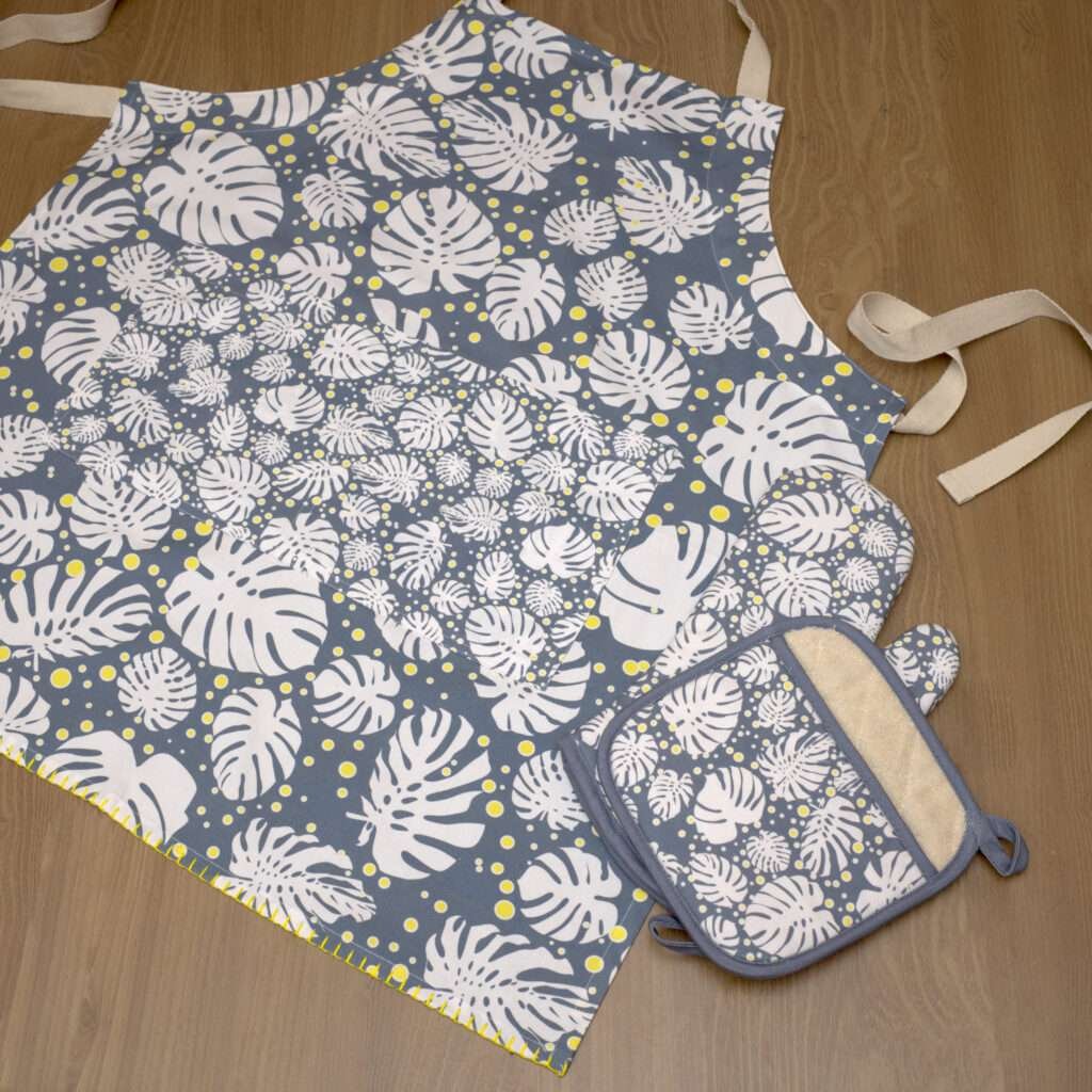 moster-ah design apron in winterf oven mitt and pot holder flat from hem and tassel