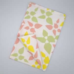 Celebration design tea towel in blush flat folded from hem and tassel