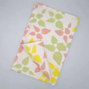 Celebration design tea towel in blush flat folded from hem and tassel