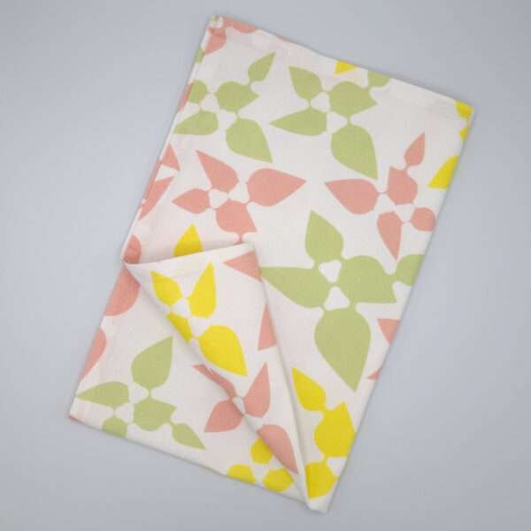 Celebration design tea towel in blush flat folded from hem and tassel