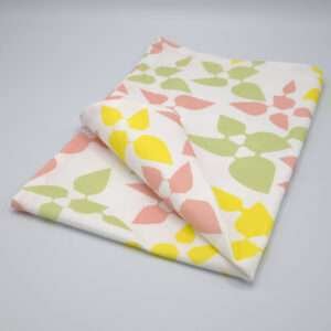 Celebration design tea towel in blush folded from hem and tassel