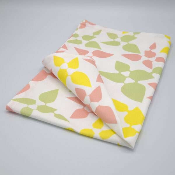 Celebration design tea towel in blush folded from hem and tassel