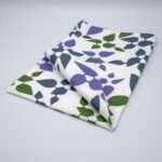 Celebration design tea towel in oil folded from hem and tassel
