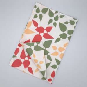 Celebration design tea towel in pink flat folded from hem and tassel