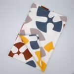 Flock and Flutter design tea towel in grey flat folded from hem and tassel