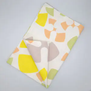 Flock and Flutter design tea towel in slate flat folded from hem and tassel