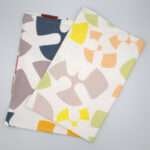 Flock and Flutter design tea towels in slate and grey flat folded from hem and tassel