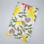 Just leaves design yellow oak tea towel flat folded from hem and tassel
