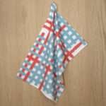 Jute Impossible checked design hanging tea towel in bluye from hem and tassel