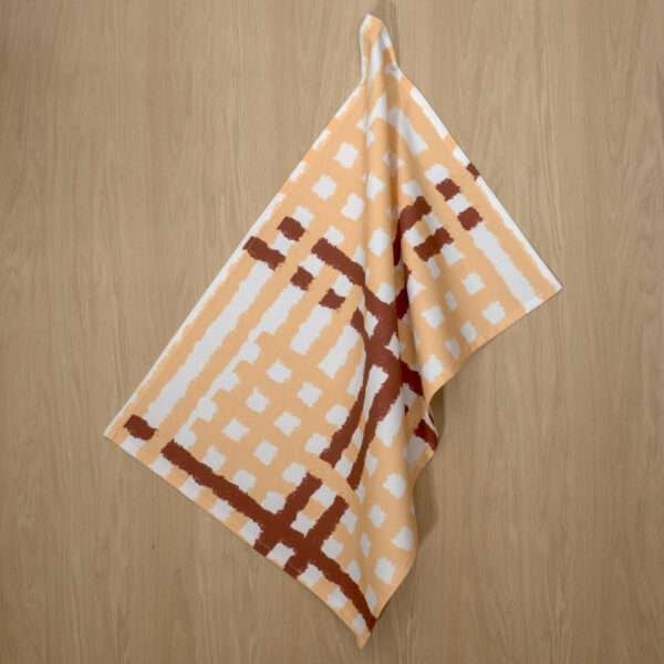 Jute Impossible checked design hanging tea towel in buff from hem and tassel