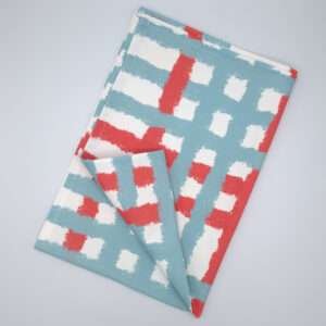 Jute impossible checked design tea towel flat folded in blue from hem and tassel