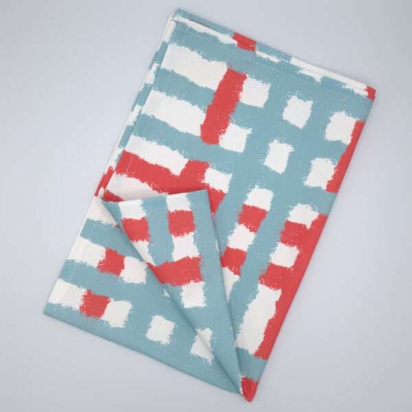 Jute impossible checked design tea towel flat folded in blue from hem and tassel