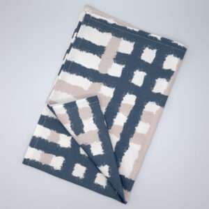 Jute impossible checked design tea towel flat folded in slate from hem and tassel