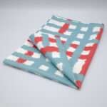 Jute impossible checked design tea towel folded in blue from hem and tassel