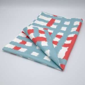 Jute impossible checked design tea towel folded in blue from hem and tassel