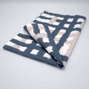 Jute impossible checked design tea towel folded in slate from hem and tassel