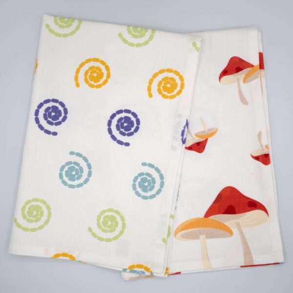 Magic and magic mushroom design tea towels fanned out from hem and tassel