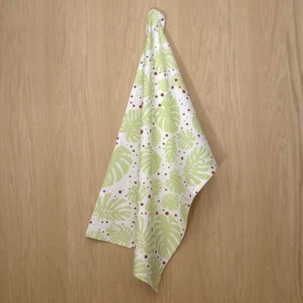 Monster Ah design hanging tea towel in mint and clay from hem and tassel