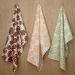 Monster Ah design three hanging tea towels from hem and tassel