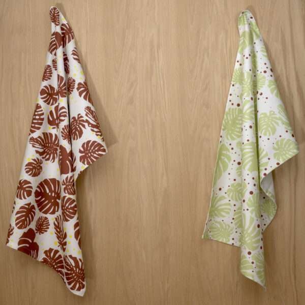 Monster Ah design two hanging tea towels from hem and tassel