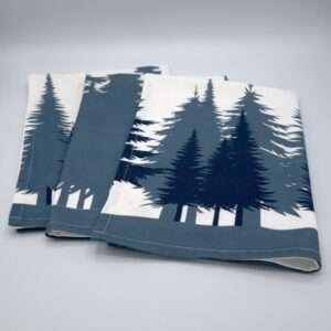 cotton kitchen towels laid out flat and fanned with park design from hem and tassel
