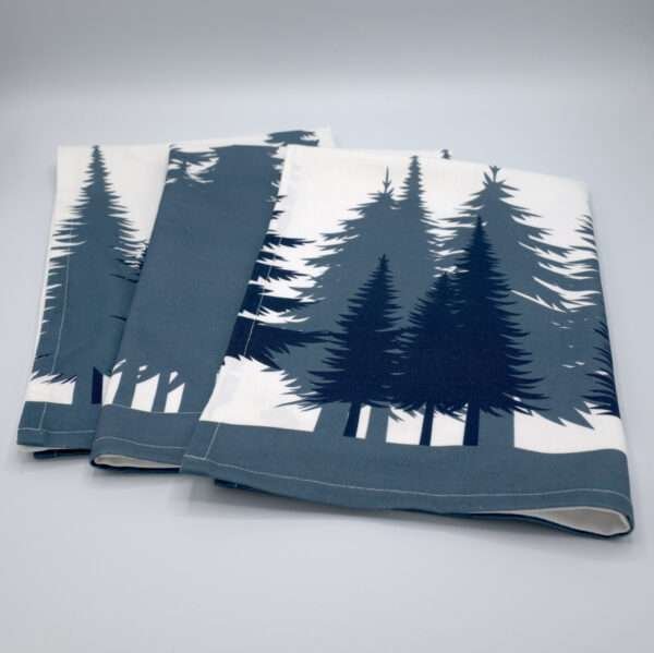 cotton kitchen towels laid out flat and fanned with park design from hem and tassel