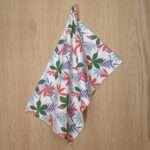 Pollen Up design hanging tea towel in pink from hem and tassel