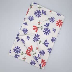 Shy dragonfly hiding design tea towel in purple and pink flat folded from hem and tassel