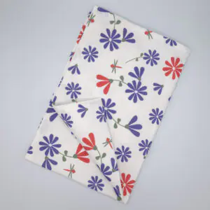 Shy dragonfly hiding design tea towel in purple and pink flat folded from hem and tassel