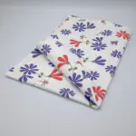 kitchen towel in shy dragonfly hiding design with purple and pink flowers