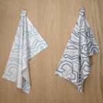 Squiggles geometry design hanging tea towels in blue and oil from hem and tassel