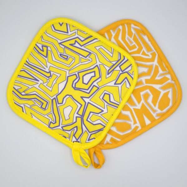 Squiggles maze design hot pads in orange and yellow from hem and tassel