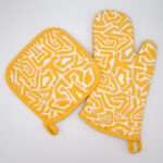 Squiggles maze design mitt and hot pad in orange from hem and tassel