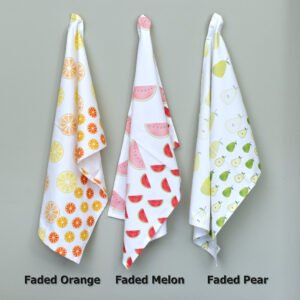 Three hanging towels of faded fruit design